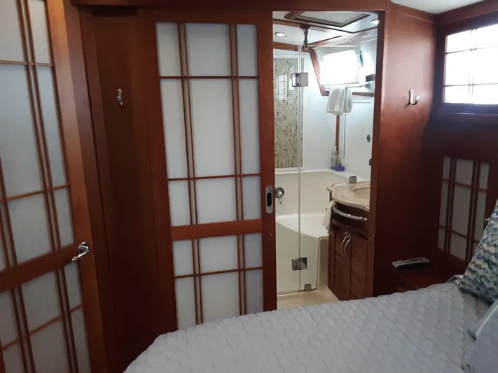 Happy Days Yacht Photos Pics Interior of 2016 Sabre 48 Salon Express yacht with wooden sliding doors and modern bathroom.