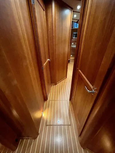 Happy Days Yacht Photos Pics 2016 Sabre 48 Salon Express interior hallway with wooden paneling and flooring.