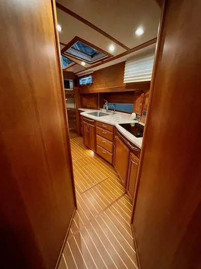 Happy Days Yacht Photos Pics 2016 Sabre 48 Salon Express interior with wood finish and modern kitchen amenities.