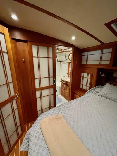 Happy Days Yacht Photos Pics 2016 Sabre 48 Salon Express bedroom with wooden accents and cozy bedding.