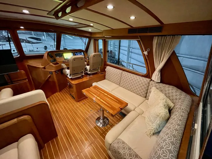 Happy Days Yacht Photos Pics Luxurious interior of 2016 Sabre 48 Salon Express yacht with elegant seating and helm.