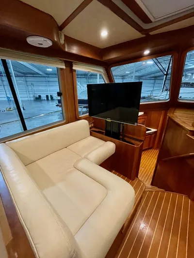 Happy Days Yacht Photos Pics Interior of 2016 Sabre 48 Salon Express yacht with leather seating and TV.