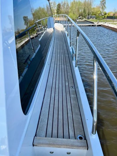  Yacht Photos Pics 2021 Van der Heijden Phantom 70 Fly yacht deck with sleek wooden walkway.