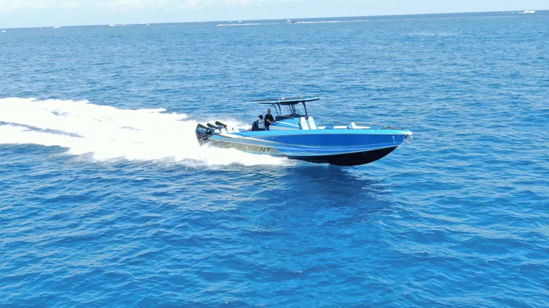 Riptide Yacht Photos Pics 2023 Statement 380 Open speedboat cruising on open blue ocean waters.