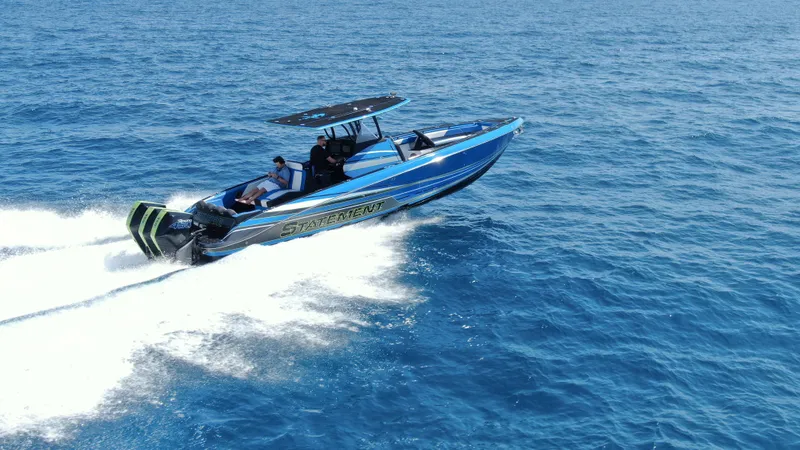 Riptide Yacht Photos Pics 2023 Statement 380 Open boat cruising on clear blue ocean waters.