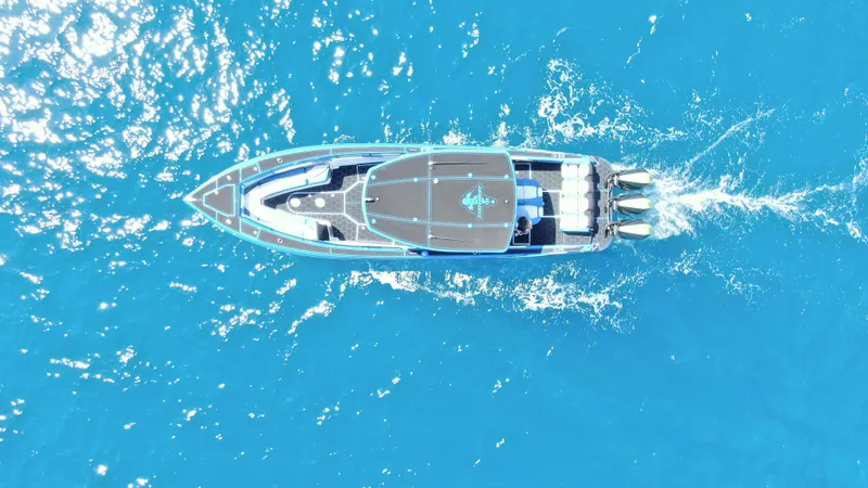 Riptide Yacht Photos Pics Aerial view of 2023 Statement 380 Open boat cruising in clear blue water.