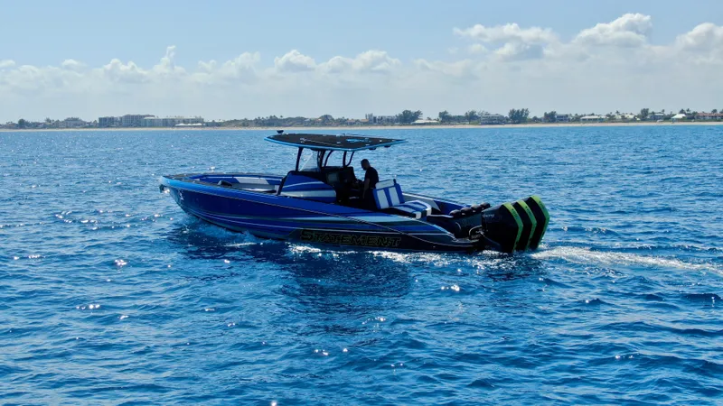 Riptide Yacht Photos Pics 2023 Statement 380 Open boat cruising on clear blue ocean waters.