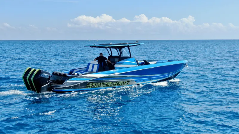 Riptide Yacht Photos Pics 2023 Statement 380 Open boat cruising on clear blue ocean waters.