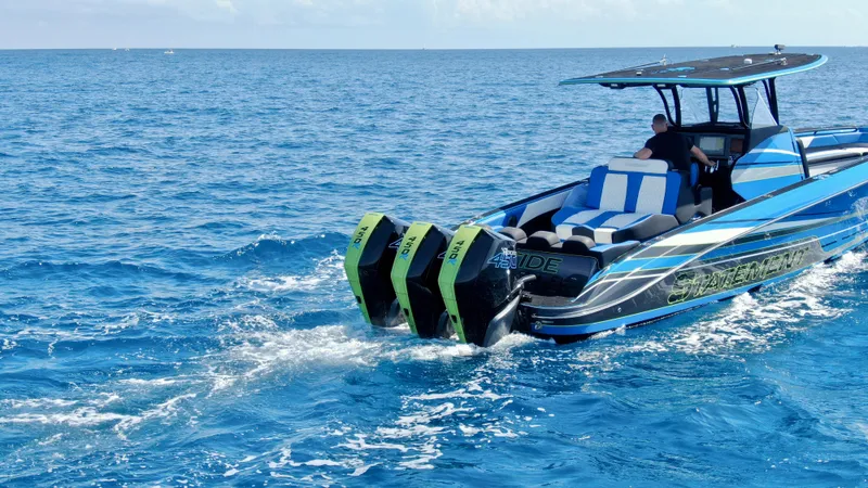 Riptide Yacht Photos Pics 2023 Statement 380 Open boat cruising on open blue sea with triple engines.