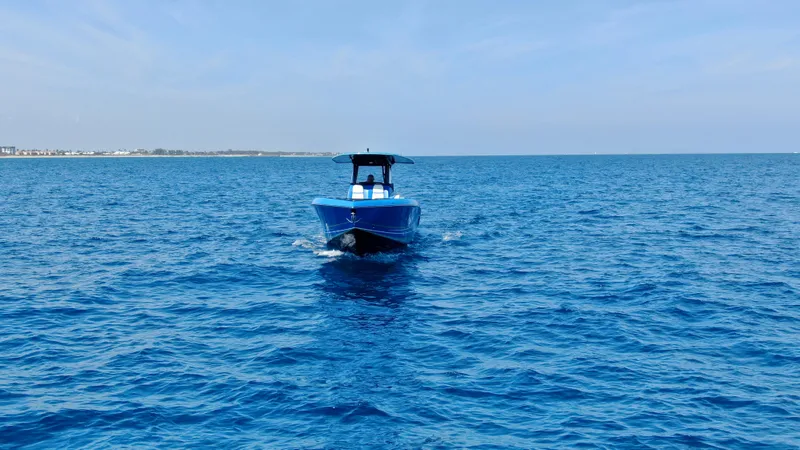 Riptide Yacht Photos Pics 2023 Statement 380 Open boat cruising on open blue sea.