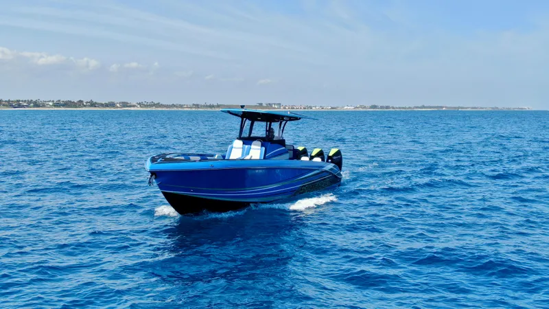 Riptide Yacht Photos Pics 2023 Statement 380 Open boat cruising on clear blue ocean waters.