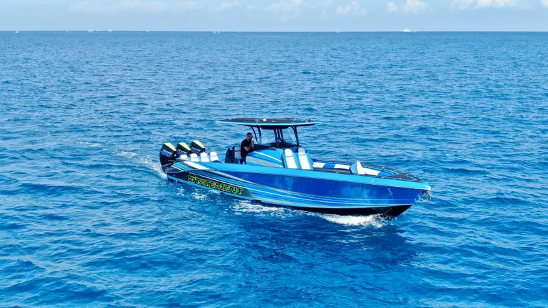 Riptide Yacht Photos Pics 2023 Statement 380 Open boat cruising on clear blue ocean waters.