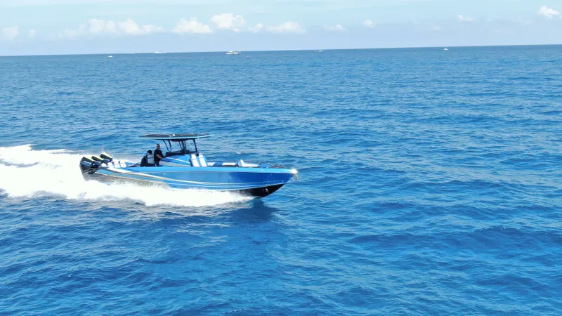 Riptide Yacht Photos Pics 2023 Statement 380 Open boat cruising on open blue ocean waters.