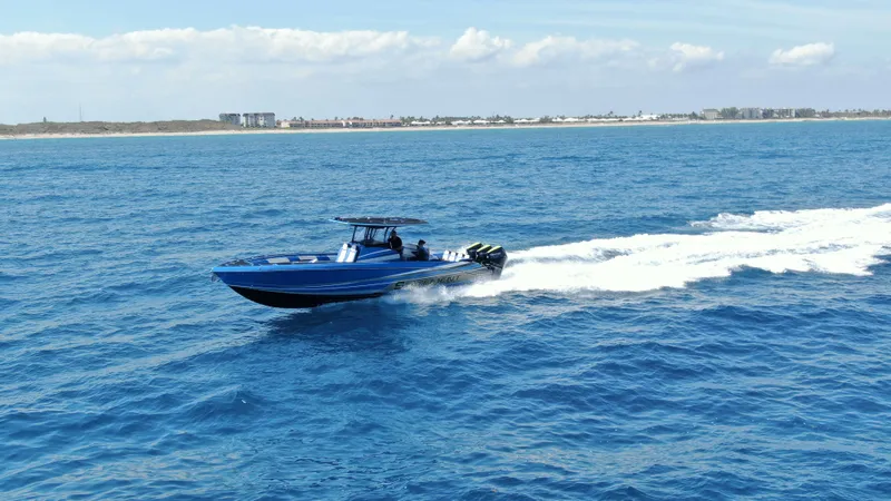 Riptide Yacht Photos Pics 2023 Statement 380 Open boat cruising on open sea, clear blue water, sunny day.