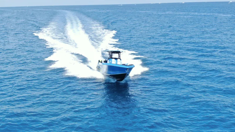 Riptide Yacht Photos Pics 2023 Statement 380 Open boat speeding on open blue ocean waters.