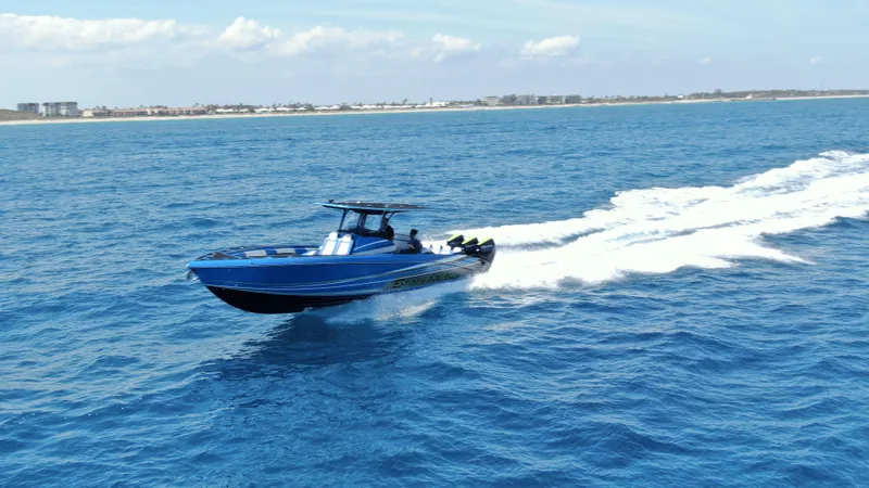 Riptide Yacht Photos Pics 2023 Statement 380 Open boat cruising on open blue ocean waters.