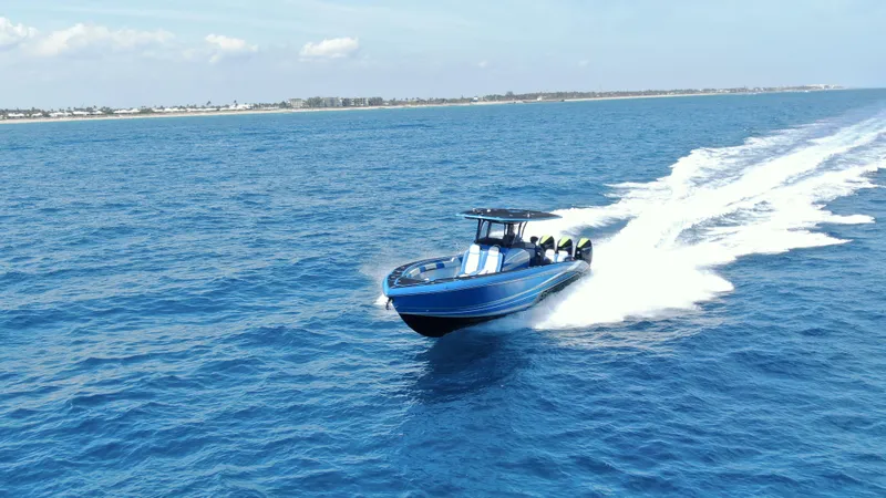Riptide Yacht Photos Pics 2023 Statement 380 Open boat cruising on open blue ocean waters.