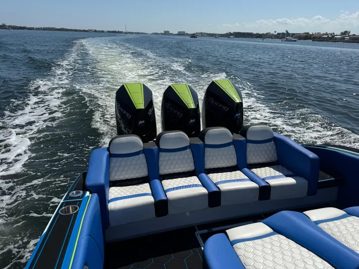 Riptide Yacht Photos Pics 2023 Statement 380 Open boat with triple engines cruising on open water.
