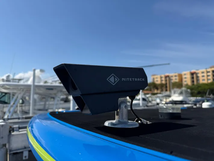 Riptide Yacht Photos Pics NiteTrack camera on 2023 Statement 380 Open boat, docked with clear sky background.