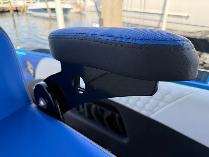 Riptide Yacht Photos Pics Blue seat detail on 2023 Statement 380 Open boat, docked by water.