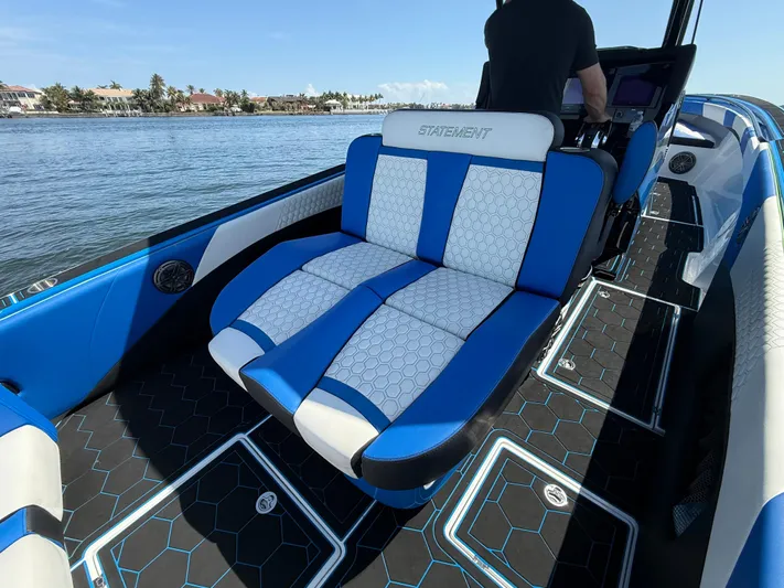 Riptide Yacht Photos Pics 2023 Statement 380 Open boat with blue and white seating on a sunny day.