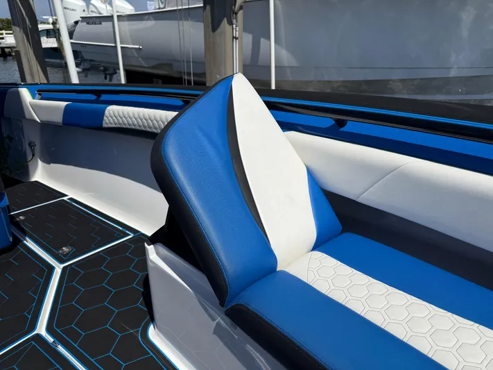 Riptide Yacht Photos Pics 2023 Statement 380 Open boat interior with blue and white seating, hexagonal floor pattern.