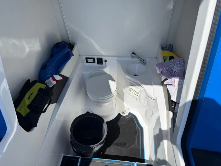 Riptide Yacht Photos Pics Interior of 2023 Statement 380 Open boat bathroom with toilet and sink.