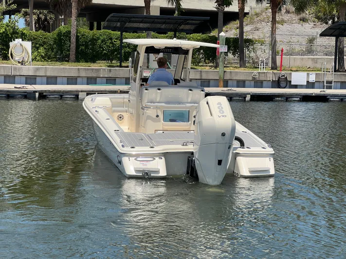  Yacht Photos Pics 2025 Scout 281 XSS boat docked in a marina, rear view.