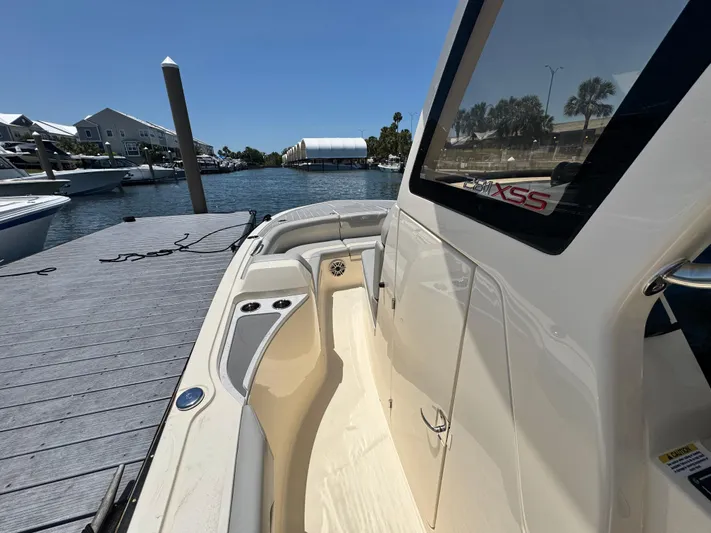  Yacht Photos Pics 2025 Scout 281 XSS boat docked by a scenic waterfront.