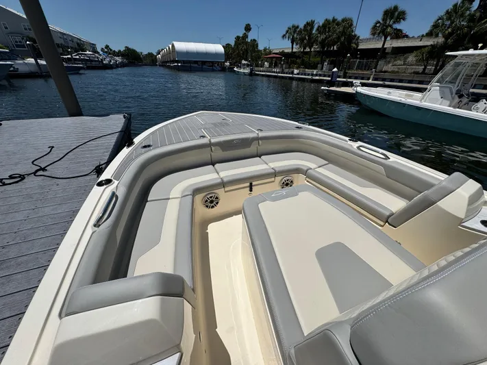  Yacht Photos Pics 2025 Scout 281 XSS boat interior with seating, docked by a marina.