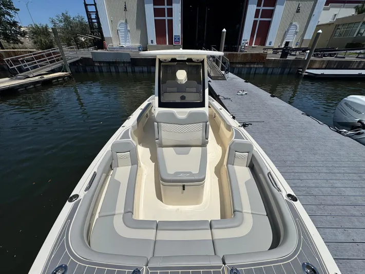  Yacht Photos Pics 2025 Scout 281 XSS boat docked, showcasing spacious seating and sleek design.