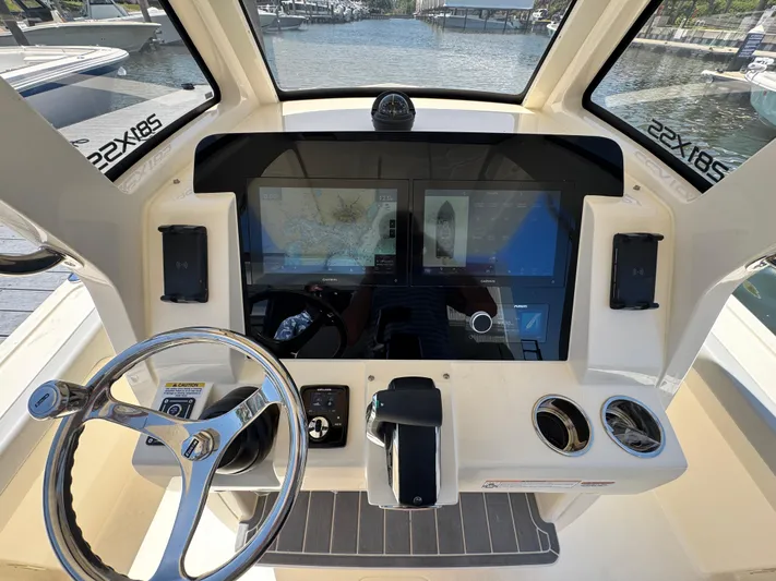  Yacht Photos Pics 2025 Scout 281 XSS boat dashboard with dual screens and steering wheel.
