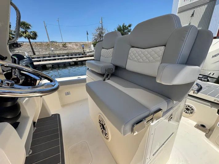  Yacht Photos Pics 2025 Scout 281 XSS boat interior with gray seating and steering wheel.