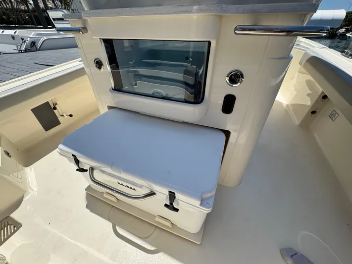  Yacht Photos Pics 2025 Scout 281 XSS boat interior with storage compartment and cooler.