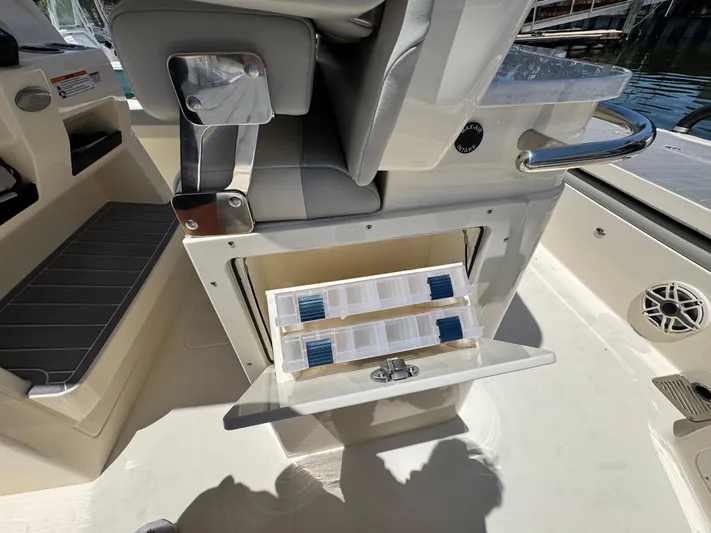  Yacht Photos Pics 2025 Scout 281 XSS boat interior with open storage compartment and seating.