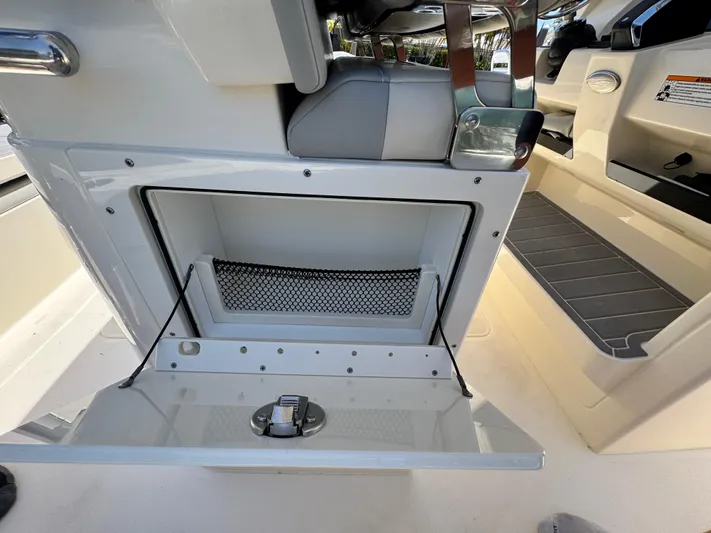  Yacht Photos Pics 2025 Scout 281 XSS boat interior storage compartment with open hatch and netting.