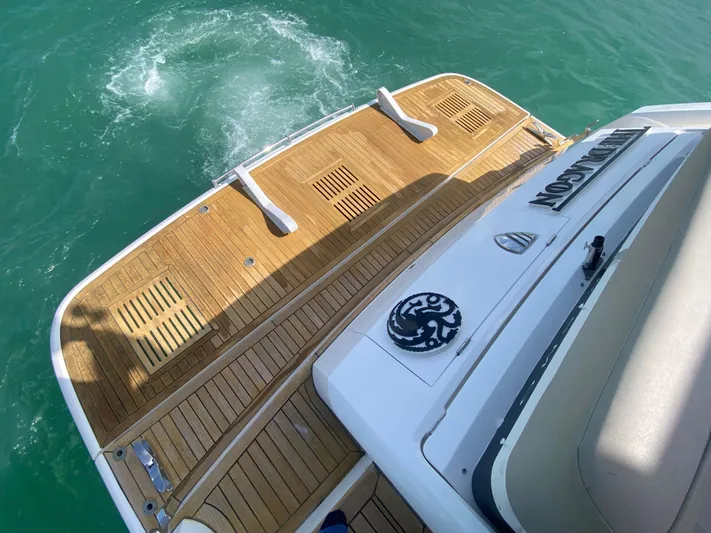 2022 Fairline Targa 50 Gt Yacht Photos Pics 2022 Fairline Targa 50 GT yacht with teak swim platform on turquoise water.