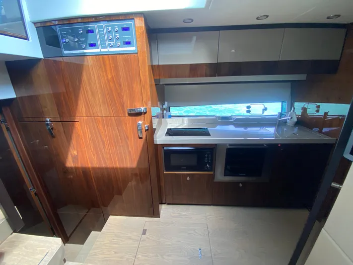 2022 Fairline Targa 50 Gt Yacht Photos Pics Modern kitchen interior of 2022 Fairline Targa 50 GT yacht with wood cabinetry.