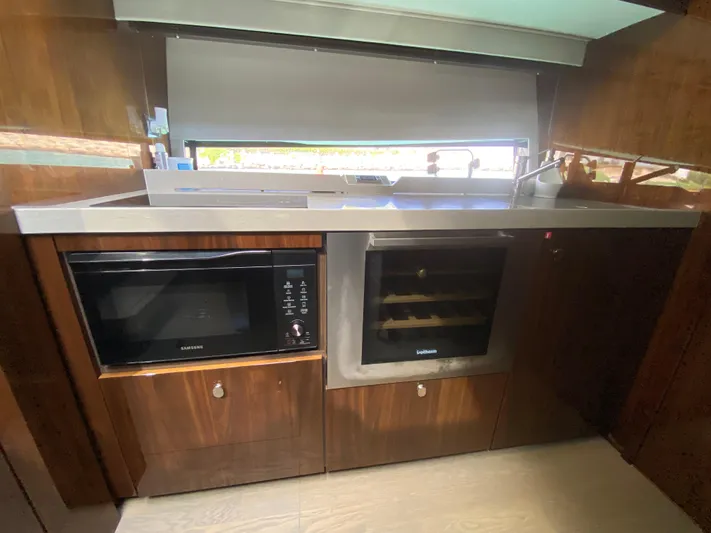 2022 Fairline Targa 50 Gt Yacht Photos Pics Modern kitchen in 2022 Fairline Targa 50 GT yacht with microwave and wine cooler.
