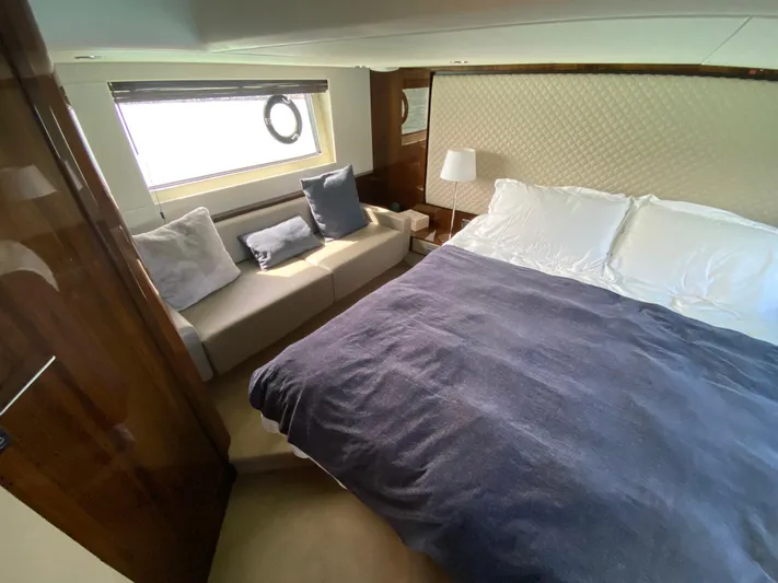 2022 Fairline Targa 50 Gt Yacht Photos Pics Luxurious bedroom interior of 2022 Fairline Targa 50 GT yacht with cozy bed and seating.
