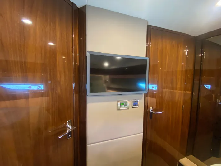 2022 Fairline Targa 50 Gt Yacht Photos Pics Luxurious interior of 2022 Fairline Targa 50 GT yacht with sleek wood paneling and mounted TV.