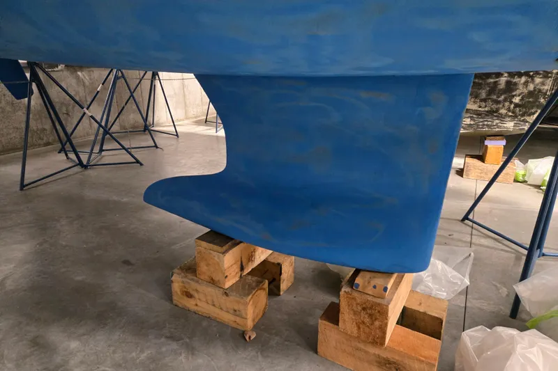 Mahalo Yacht Photos Pics Blue keel of a 2021 Beneteau Oceanis 30.1 sailboat on wooden blocks.