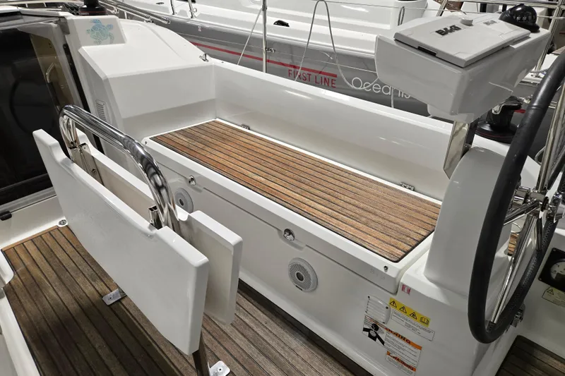 Mahalo Yacht Photos Pics 2021 Beneteau Oceanis 30.1 yacht cockpit with teak flooring and steering wheel.