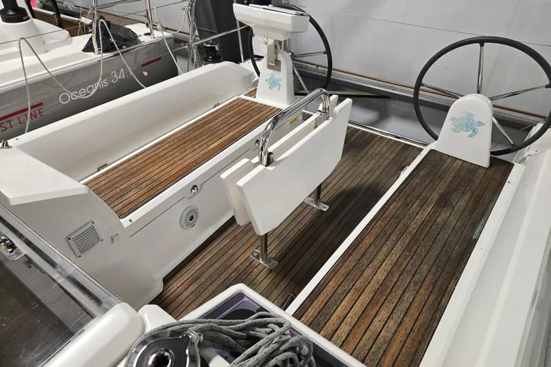 Mahalo Yacht Photos Pics Cockpit of 2021 Beneteau Oceanis 30.1 sailboat with dual steering wheels and teak flooring.