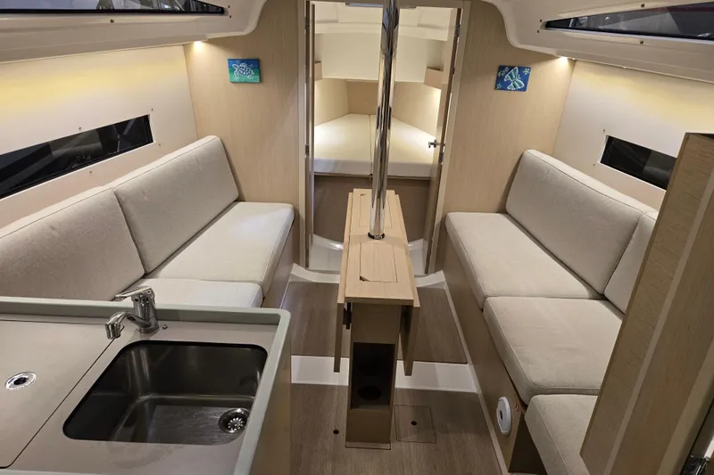 Mahalo Yacht Photos Pics Interior of 2021 Beneteau Oceanis 30.1 yacht with modern seating and kitchenette.