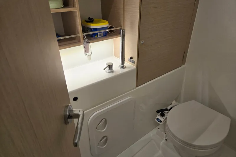 Mahalo Yacht Photos Pics Compact bathroom in 2021 Beneteau Oceanis 30.1 yacht with sink and toilet.