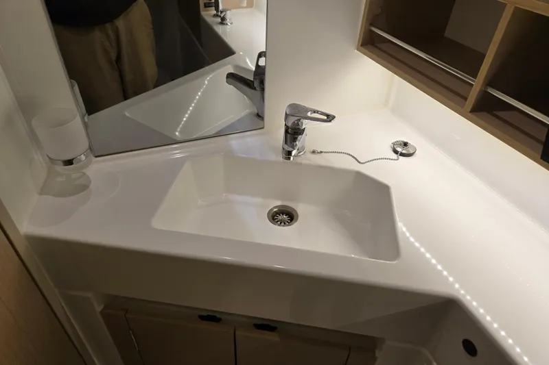 Mahalo Yacht Photos Pics Modern bathroom sink in 2021 Beneteau Oceanis 30.1 yacht, featuring sleek design and fixtures.