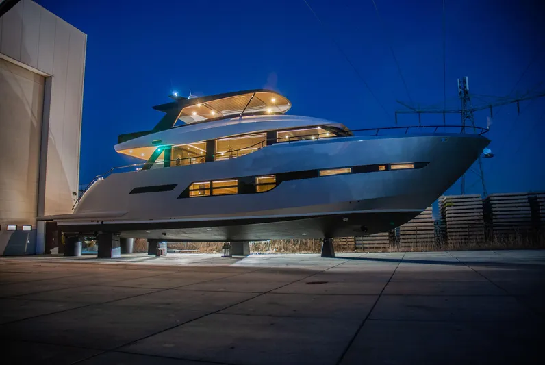  Yacht Photos Pics 2024 Van der Heijden Phantom Expedition yacht illuminated at night in a shipyard.
