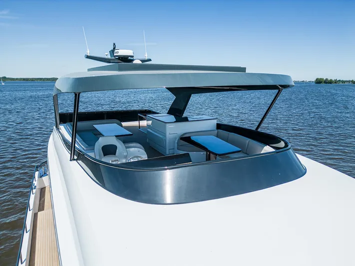  Yacht Photos Pics 2024 Van der Heijden Phantom Expedition yacht on calm water, featuring spacious deck seating.