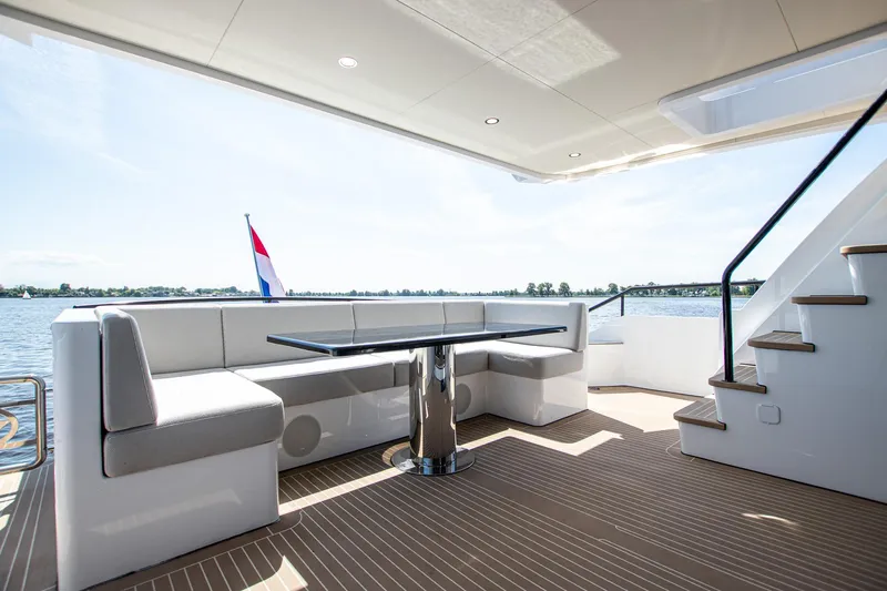  Yacht Photos Pics Luxurious 2024 Van der Heijden Phantom Expedition yacht deck with seating and scenic water view.